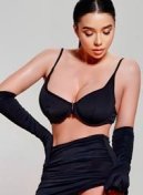 Karan thumbnail - busty English escort London in a black bra and gloves
