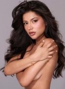Julia thumbnail with long dark wavy hair, arms crossed