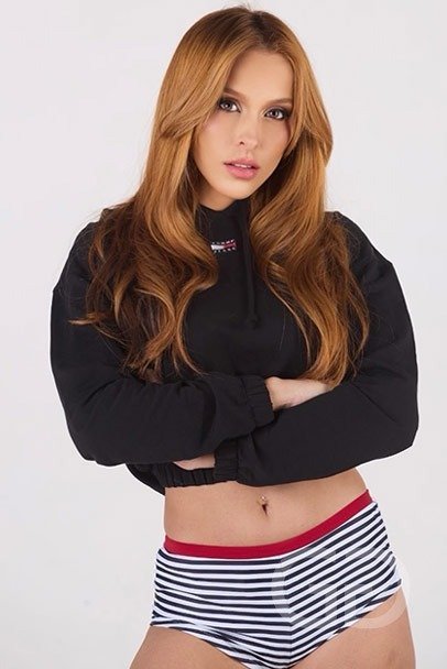 Luceria, Latin escort, in a black cropped hoodie and striped briefs