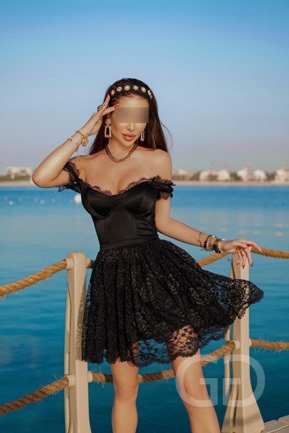 Veronica in a black corset dress with a lace skirt by the sea