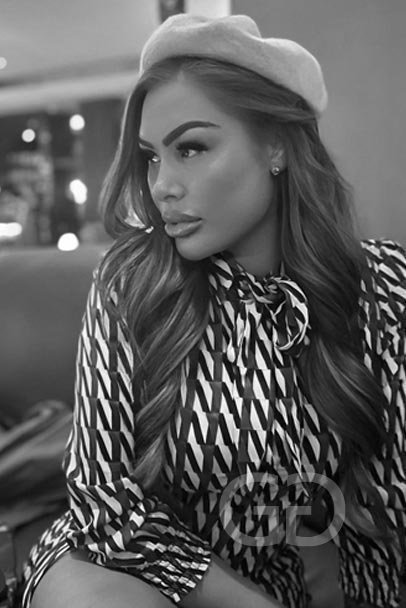 Alva in a beret and patterned blouse, black and white portrait