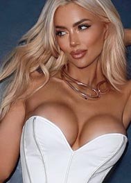 Devon thumbnail in a white corset top and silver necklace
